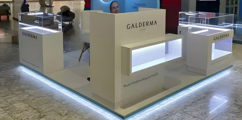 Minimalist white cosmetic brand kiosk with Corian countertop and integrated LED lighting